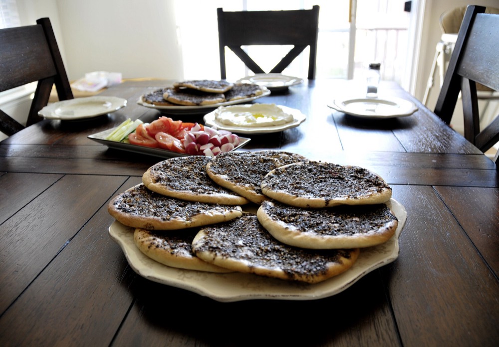 A stack of zaatar manakish on a breakfast table