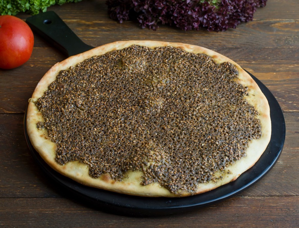 Zaatar manakish on a dark tray